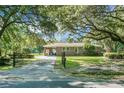 Charming brick home with lush front lawn, mature trees, and gated driveway at 4428 Maple Ridge Rd, Walterboro, SC 29488