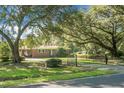 Charming brick home with lush front lawn, mature trees, and gated driveway at 4428 Maple Ridge Rd, Walterboro, SC 29488