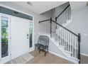 Bright foyer featuring hardwood floors, a staircase with dark wood accents, and a bench at 468 Maple Oak Ln, Charleston, SC 29414