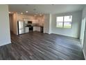 Open-concept living space with wood floors and stainless steel appliances at 495 Colchester Ct, Moncks Corner, SC 29461