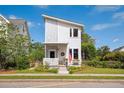 Inviting two-story home with a stylish facade, manicured lawn, and a cozy front porch with American flag at 5017 W Liberty Park Cir, North Charleston, SC 29405