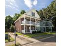 Charming brick home with double balconies and mature landscaping, offering classic curb appeal at 5110 Hyde Park Village Ln, North Charleston, SC 29405