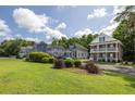 Picturesque street with well-maintained homes and green spaces, showcasing a serene neighborhood setting at 5110 Hyde Park Village Ln, North Charleston, SC 29405