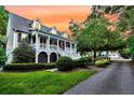 Lovely home featuring a welcoming porch, well-maintained landscaping, and a driveway leading to the side at 512 Whilden St, Mount Pleasant, SC 29464