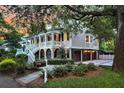 Elegant home with a large porch, ground level garages and manicured greenery surrounding the property at 512 Whilden St, Mount Pleasant, SC 29464