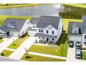 Aerial view of a beautiful two-story home with a well-manicured lawn, landscaping, and a scenic pond at 513 Richfield Way, Summerville, SC 29486