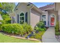 Close-up of the house's front entrance, accented with lush landscaping and decorative lighting at 5406 E Crosland Ct, North Charleston, SC 29420