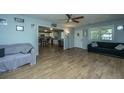 Cozy living room with wood-look flooring and an open layout to the kitchen at 565 Estates Dr, Walterboro, SC 29488
