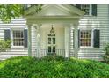 Inviting front porch with classic white columns and manicured greenery at 6 Sayle Rd, Charleston, SC 29407