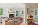 Bright living room featuring a fireplace, hardwood floors, and a cozy seating area at 6 Sayle Rd, Charleston, SC 29407