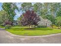 Beautifully landscaped property featuring lush green lawn, mature trees and attractive curb appeal at 801 Long Drive Rd, Summerville, SC 29485