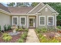 Inviting home entrance with manicured garden, water feature and cozy bench seating at 801 Long Drive Rd, Summerville, SC 29485
