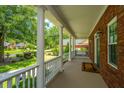 Inviting front porch with white columns and a swing, offering a relaxing outdoor space at 8725 Herons Walk, North Charleston, SC 29420