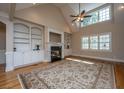 Bright living room featuring a fireplace with built-in shelves and large windows at 8725 Herons Walk, North Charleston, SC 29420