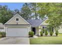 Inviting single-Gathering home featuring a well-kept lawn, attached garage, and a welcoming entrance at 9016 Greenbriar Dr, Summerville, SC 29485