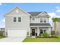 Inviting two-story home with gray siding, well-kept lawn, and a two-car garage under a blue sky at 102 Bolsena Ct, Summerville, SC 29486