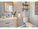 Stylish powder room with modern fixtures, shiplap walls, and decorative shelving at 1052 Whitlow Blvd, Summerville, SC 29483