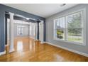 Bright living room with hardwood floors, large windows, and architectural columns at 1070 Moss Grove Dr, Moncks Corner, SC 29461