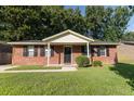 A single-story brick home with black shutters, a well-maintained lawn, and a welcoming front porch at 109 Ashdown Dr, Summerville, SC 29483