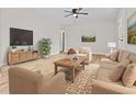 Inviting living room featuring neutral furniture, wood floors, and a large television at 109 Ashdown Dr, Summerville, SC 29483