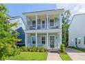 Charming two-story home with a inviting double porch, lush landscaping, and private driveway at 109 W Respite Ln, Summerville, SC 29483