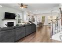 Spacious living room featuring a modern fireplace, wood floors, and an open layout to the kitchen at 109 W Respite Ln, Summerville, SC 29483