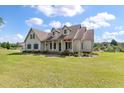 Inviting home exterior featuring a manicured lawn, covered porch, and tasteful landscaping at 1111 Sandy Springs Circle, Walterboro, SC 29488