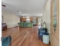 Open-concept living area flowing into a kitchen with hardwood floors and natural light at 1111 Sandy Springs Circle, Walterboro, SC 29488