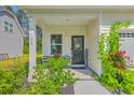Charming front porch with black welcome door, chairs, and beautiful flowering plants at 115 Cooper Dr, Summerville, SC 29483