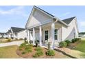 Inviting front porch features stylish seating and lovely landscaping at 1213 Locals St, Summerville, SC 29485