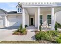 Charming front porch with seating and manicured landscaping at 1213 Locals St, Summerville, SC 29485