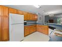 Functional kitchen featuring wood cabinets, laminate countertops, and white appliances at 122 Stewart Pl, Summerville, SC 29485