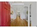Elegant foyer with hardwood floors, white pillars, and a view into the living spaces showcasing the home's design at 1228 Walleye Cor, Charleston, SC 29414