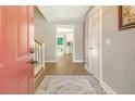 Bright foyer with hardwood floors, neutral walls, and a glimpse into the modern kitchen beyond at 125 Sumners Aly, Summerville, SC 29485