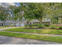 A beautiful single-Gathering home has a well-manicured lawn, mature tree and brick exterior at 125 Sumners Aly, Summerville, SC 29485
