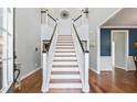 Bright foyer featuring hardwood floors, a stairway, and neutral gray walls at 129 Saluda Dr, Moncks Corner, SC 29461