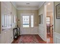 Inviting foyer with hardwood floors, decorative rug, and a view into the adjacent dining area at 129 Schooner Bend Ave, Summerville, SC 29486