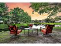 Relaxing backyard seating area with lake view, perfect for outdoor enjoyment and peaceful contemplation at 1311 Royal Links Dr, Mount Pleasant, SC 29466