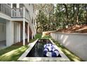 Backyard view of the home's rectangle pool and patio featuring manicured grass at 14 55Th Ave, Isle of Palms, SC 29451