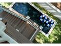 Top view of the home's outdoor rectangle pool, patio and surrounding greenery at 14 55Th Ave, Isle of Palms, SC 29451