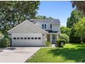 Charming two-story home with a two car garage, beautiful landscaping, and a welcoming front entrance with a wreath at 1406 Oaklanding Rd, Mount Pleasant, SC 29464