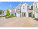 Inviting townhome exteriors with colorful siding, driveways, and landscaped front yards at 166 Rosefield Ct, Summerville, SC 29485