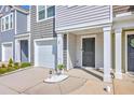 Exterior of townhome features a garage, and a covered porch with front door at 166 Rosefield Ct, Summerville, SC 29485
