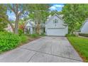 Attractive two-story home with mature landscaping and a concrete driveway leading to a two-car attached garage at 1972 Gray Battery Ct, Mount Pleasant, SC 29464