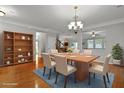 Elegant dining room featuring hardwood floors, modern table and chairs, and chandelier lighting at 200 Commencement Blvd, Ladson, SC 29456