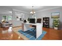 Bright home office with hardwood floors, area rug, chandelier lighting and lots of natural light at 200 Commencement Blvd, Ladson, SC 29456