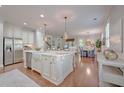 Spacious open-concept kitchen featuring a large marble island, stainless steel appliances, and hardwood floors at 2036 Kings Gate Ln, Mount Pleasant, SC 29466
