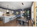 Open-concept dining room featuring modern lighting, a large table, and stylish decor at 211 Line St, Charleston, SC 29403