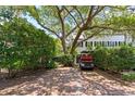Brick driveway with a golf cart parked under a large tree, offering ample parking space at 22 Lamboll St # C, Charleston, SC 29401