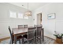 Bright dining room with wainscoting, chandelier, and large table for six at 2313 Bucktail Ct, Mount Pleasant, SC 29466